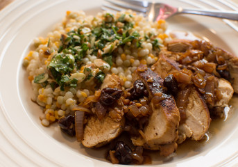 Turkey dinner with cherries and couscous grains healthy home made food on plate