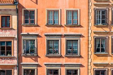 Fototapeta premium Warsaw, Poland old town market square with historic street town architecture and windows closeup pattern of red color