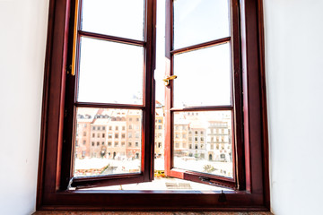 Closeup of windowsill of apartment with view of old market square in town of Warsaw Poland and open window