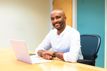 Young afro american businessman in the office with his laptop