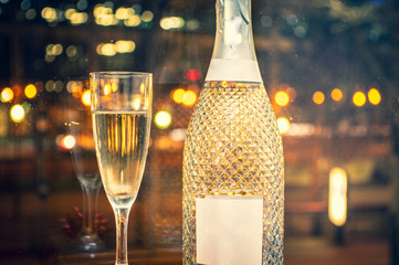 Champagne glass with fine champagne in front of the lights of a big city