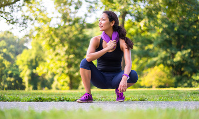 Sport asian woman with towel at the park