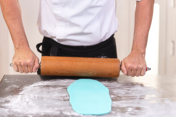 Professional confectioner making chocolate sweets at confectionery shop .