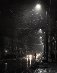 Cyclist on a night street in the rain