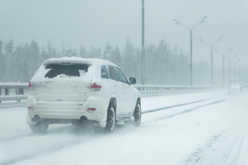 Car driving on a heavy winter road