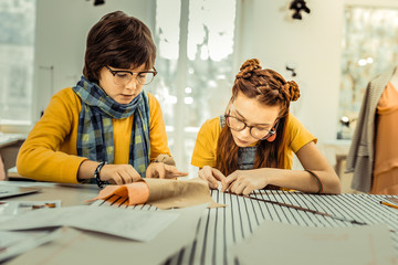 Creative future designers drafting patterns for clothes