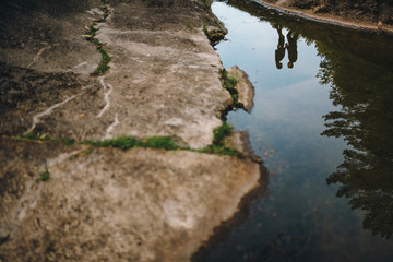 Young couple standing by the sea and looking at the sun