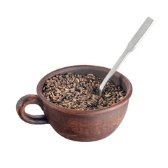 thistle seeds in pottery isolated on white background, with metal tea spoon