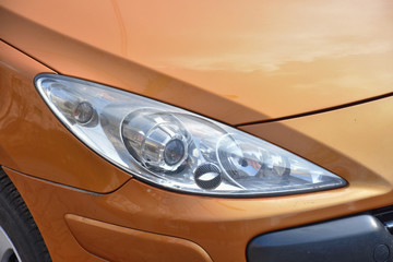 Car's exterior detail,new headlight on a  brown  car