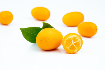 Ripe kumquats on white background