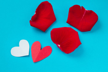 Fototapeta premium background for Valentine's day and eighth of March, rose petals and hearts on blue background.the view from the top