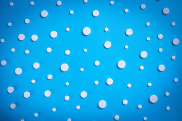 Pills, tablets on blue background