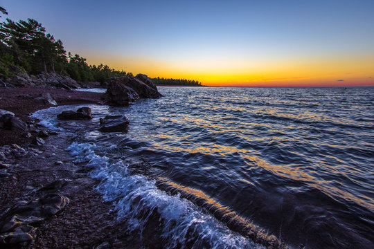 Lake Superior Twilight Beach. Beautiful sunset colors on a remote rocky beach on the coast of Lake Superior in Copper Harbor, Michigan.