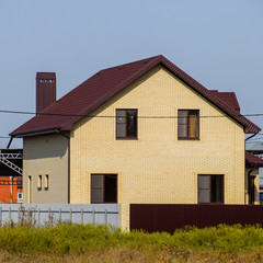 The house with plastic windows and a roof of corrugated sheet