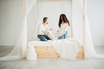 Loving couple in the bedroom with a pillow