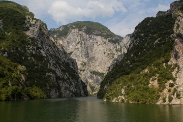 Naklejka na ściany i meble The steep mountain cliffs on the ferry on the beautiful and idyllic Koman lake in northern Albania
