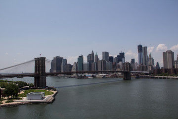 The Brooklyn bridge connecting the financial district of Manhattan island with Brooklyn is a famous landmark, popular tourist attraction and travel destination in New York City