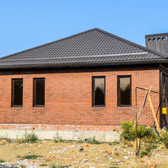 The house with plastic windows and a roof of corrugated sheet. B