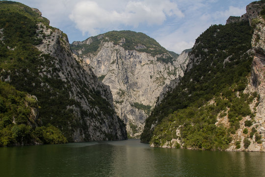 The steep mountain cliffs on the ferry on the beautiful and idyllic Koman lake in northern Albania