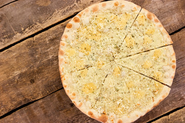 Pizza Quattro Formaggi top down view. Cheese yellow pizza slices.