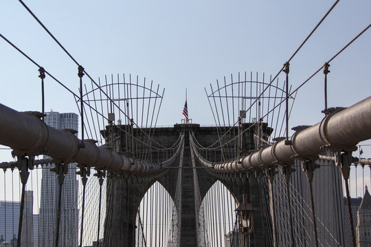 The Brooklyn bridge connecting the financial district of Manhattan island with Brooklyn is a famous landmark, popular tourist attraction and travel destination in New York City