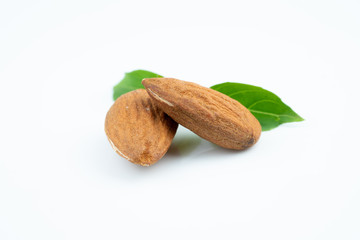 Almond and leaf on white background
