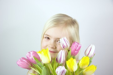 Child with a bouquet of colorful flowers