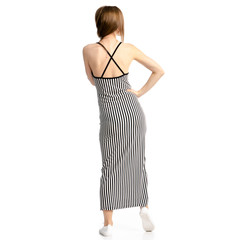 Woman in dress dancing on white background isolation, back view