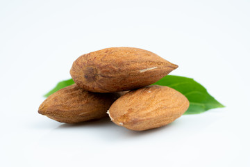 Almond and leaf on white background
