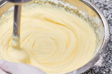 Mixing of creamy dough. Mixing dough in bowl with mixer. Baking cake.