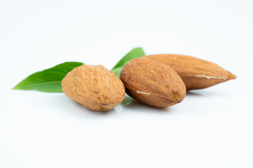 Almond and leaf on white background
