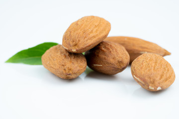 Almond and leaf on white background
