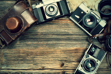 Vintage camera on wooden table and empty space for text