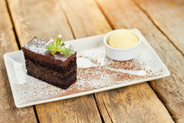 Dessert cake and mint upon it. Perfect shape of piece of cake.