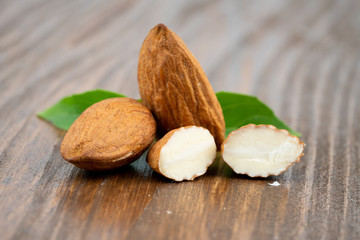 Almond and leaf on wooden
