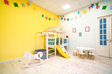 parts of the interior of the room in the kindergarten against the yellow wall - obrazy, fototapety, plakaty
