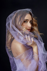 Woman wrapped in purple fabric, beautiful slim figure, purity and integrity. Perfect face skincare,...