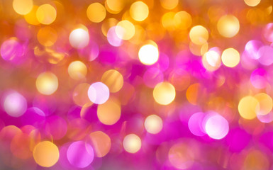 Abstract background in warm colors with bright colorful luminous bokeh