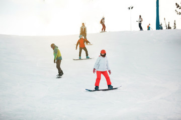 Girl try to improve her snowboarding. Sheregesh resort, Siberia, Russia