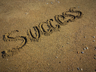 Success handwritting on sand