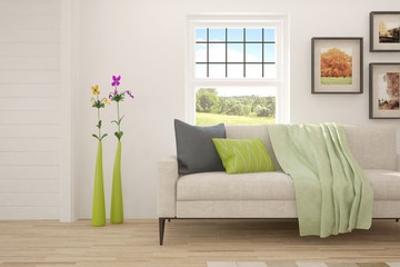 White room with sofa and green landscape in window. Scandinavian interior design. 3D illustration