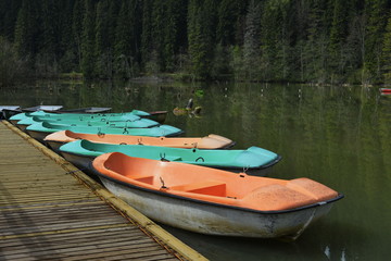 Fototapeta na wymiar Boats on the red lake, Lake Ghilco, Harghita, Romania. 2017