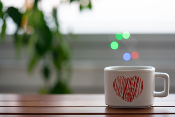 tea- coffee cup on table and bokeh