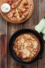 Top view of Delicious homemade pancakes with sour cream and berries