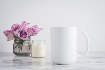 Obraz na płótnie Canvas blank white mug with roses and a candle