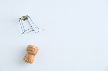 Champagne cork and metal screed for bottle myzle. On a white background. View from above.