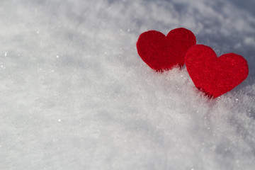 Fototapeta premium red hearts lie on fluffy snow a white background