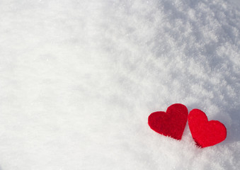 red valentines on a background of fluffy white blue snow