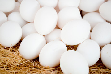 chicken fresh eggs, white, on basket at a local farmers market, ready to be sold, Milan, Italy