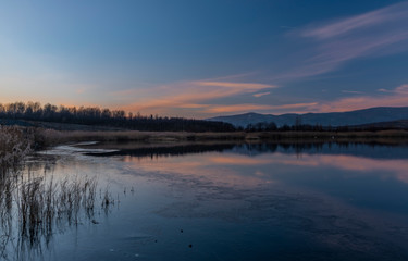 Fototapeta na wymiar Milada lake in winter cold evening in north Bohemia
